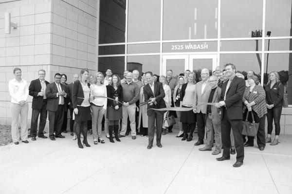 Sunrise today: On May 19, Sunrise Banks employees, city officials and members of area chambers of
commerce look on as Dave Reiling, CEO of Sunrise Banks, cuts the ribbon at the company’s new
headquarters at 2525 Wabash Ave., just west of Hwy. 280. The 57,000-square-foot building is part of the
early transformation of the industrial area near the Minneapolis-St. Paul border called the Towerside
Innovation District. The former industrial site just to the west of the building will soon see the development
of a 600- to 700-apartment complex and a 2-acre St. Paul city park.