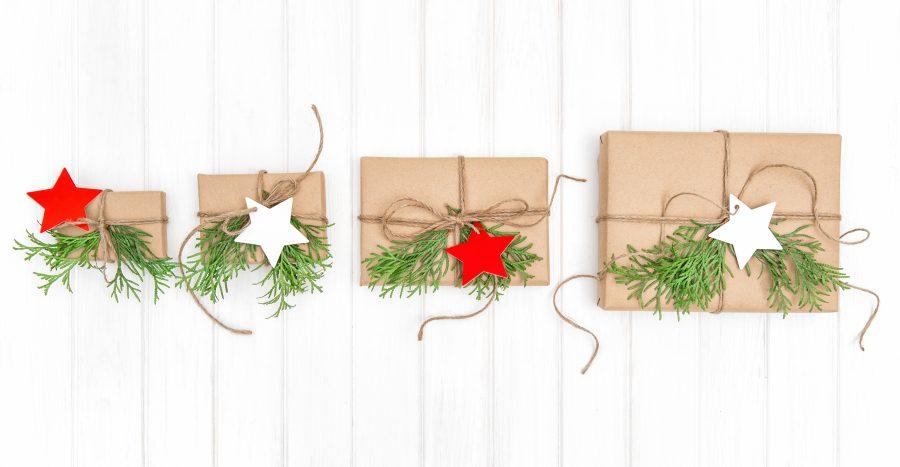 Gifts with christmas decoration on bright wooden background