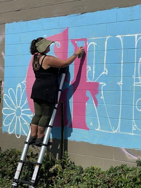 Muralist Thomasina Topbear paints a wall as part of a live-art
demonstration during the Chroma Zone Midsummer “Happening.” Photo by Sarah CR Clark.