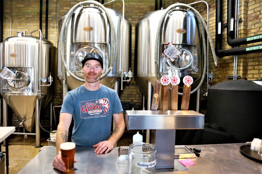 Urban Growler assistant manager Justin Lavender mans the bar.  Photo by Lou Michaels.