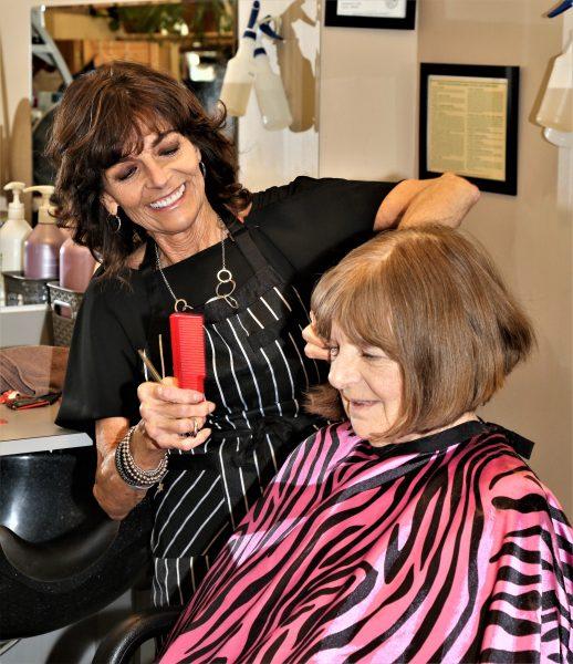 Hair salon stylist Theresa Black works on client Mary Schultz. Photo by
Lou Michaels.
