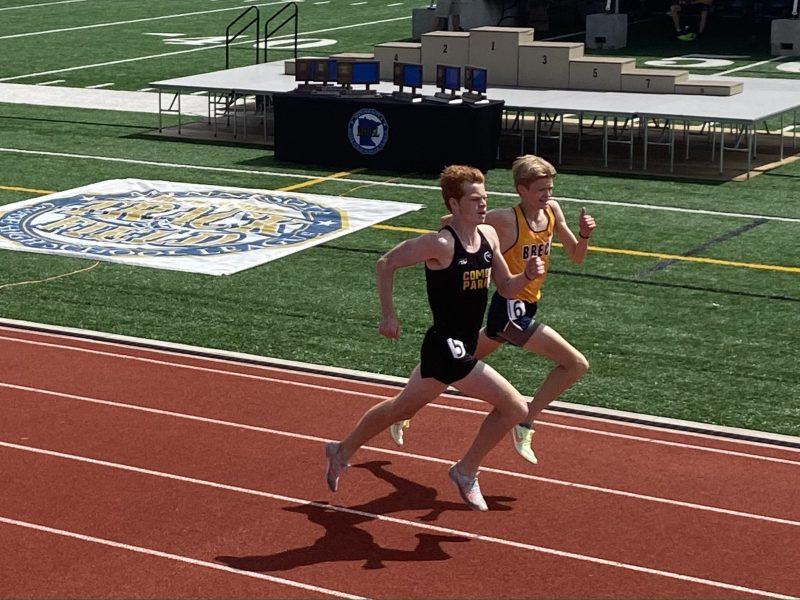 Charlie Power-Theisen passes a
competitor during the final lap of
the 1600M race at the state track meet. Photo by Eric Erickson.