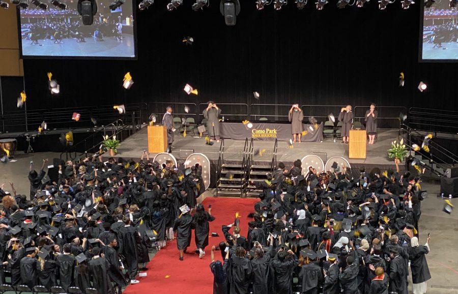 Como graduates toss their caps in the air after the conferring of diplomas at Roy Wilkins Auditorium. Photo by Lisa Sackreiter