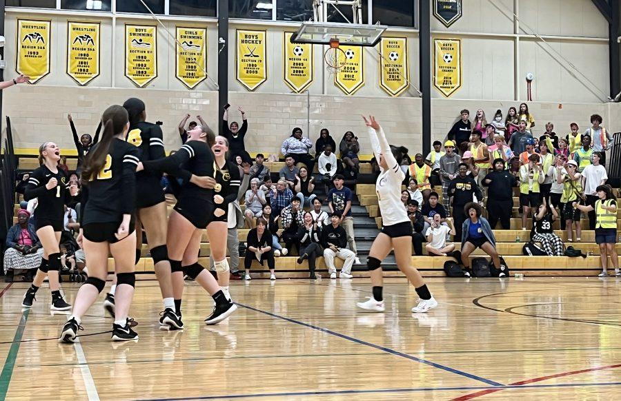 Cougar volleyball players and fans celebrate a pivotal point in their victory over Highland Park on Oct. 3. Photo by Eric Erickson.
