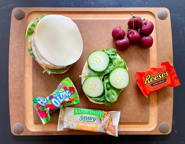 Include at least one source of grains (carbohydrates), protein, fat, and fiber (fruit/vegetable), and also something “fun.”  Photo by Jenni Wolf.