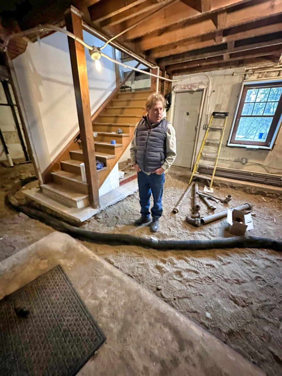 John Horchner surveys the basement flooring under construction. 